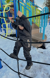 A child in trek kid black in the snow 