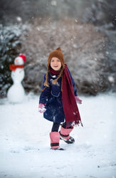 A kid in trek kid dusty rose in snow 