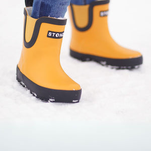 A child in urban boots sunflower in the snow 