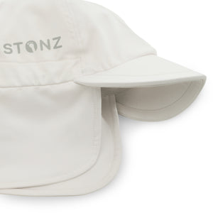 Stonz Flap Cap in Ivory, featuring an adjustable toggle for a secure fit. This lightweight, moisture-wicking sun hat offers UPF 50+ protection and full neck coverage. detail 1 view