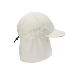Stonz Flap Cap in Ivory, featuring an adjustable toggle for a secure fit. This lightweight, moisture-wicking sun hat offers UPF 50+ protection and full neck coverage. side view
