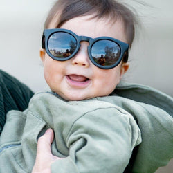 Stonz Eco Sunnies in Black, worn by a happy child.