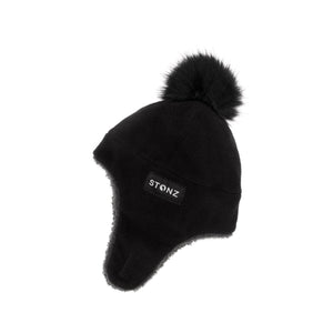 Stonz Fleece Winter Hat in Black with velcro strap and fuzzy pom pom. Side view.