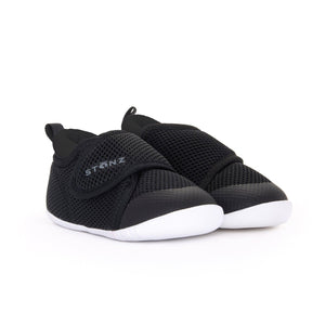 Stonz Cruiser Baby Shoe in Black, supportive baby shoe with flexible sole and breathable fabric. ¾ turn view.