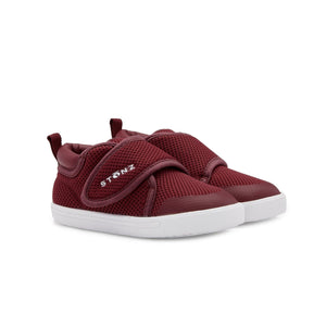 Stonz Cruiser  Toddler Shoe in Ruby Tonal. Supportive toddler runner with flexible sole and breathable fabric. ¾ turn view.
