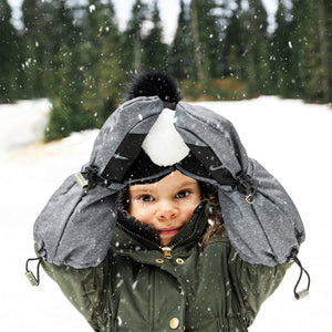 Stonz Kids Mitts in Heather Grey, worn by a child holding a snowball outside in the winter.