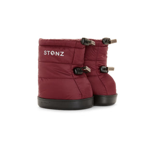 Stonz Winter Puffer Toddler Booties in Ruby with adjustable toggles, weather resistant material and non-slip soles. ¾ turn view.